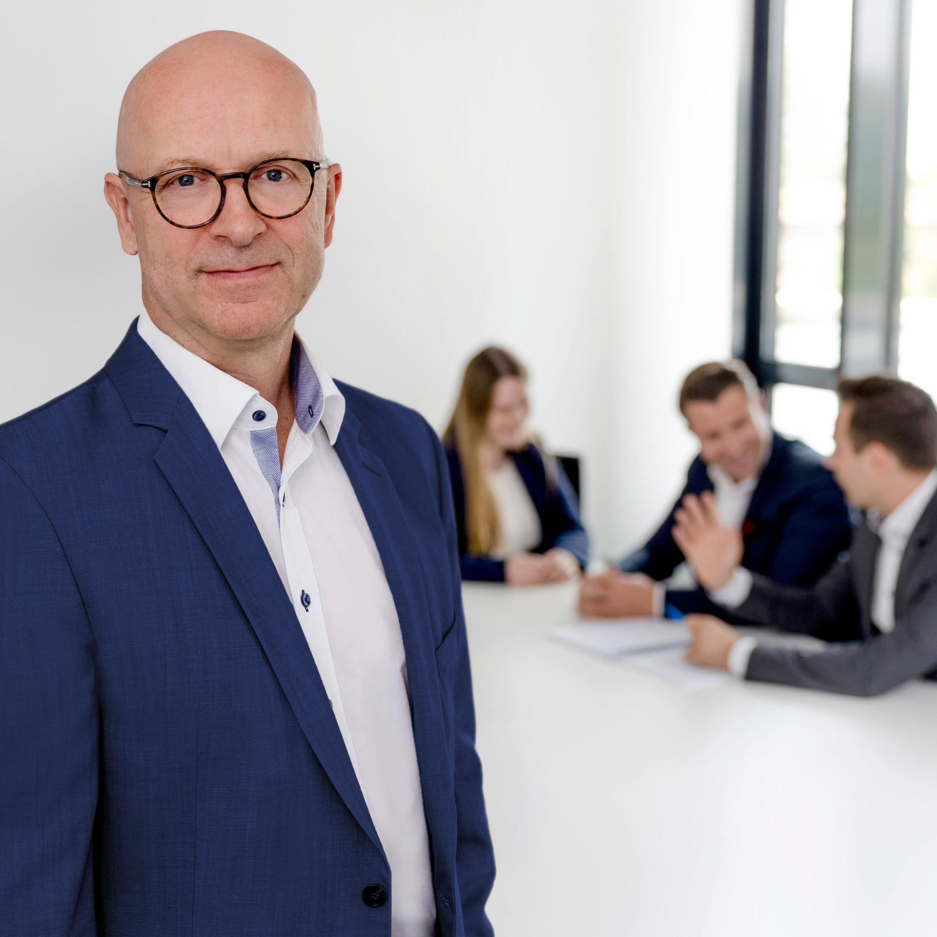 A lawyer from activeMind.legal stands in front of his data protection team at the law firm