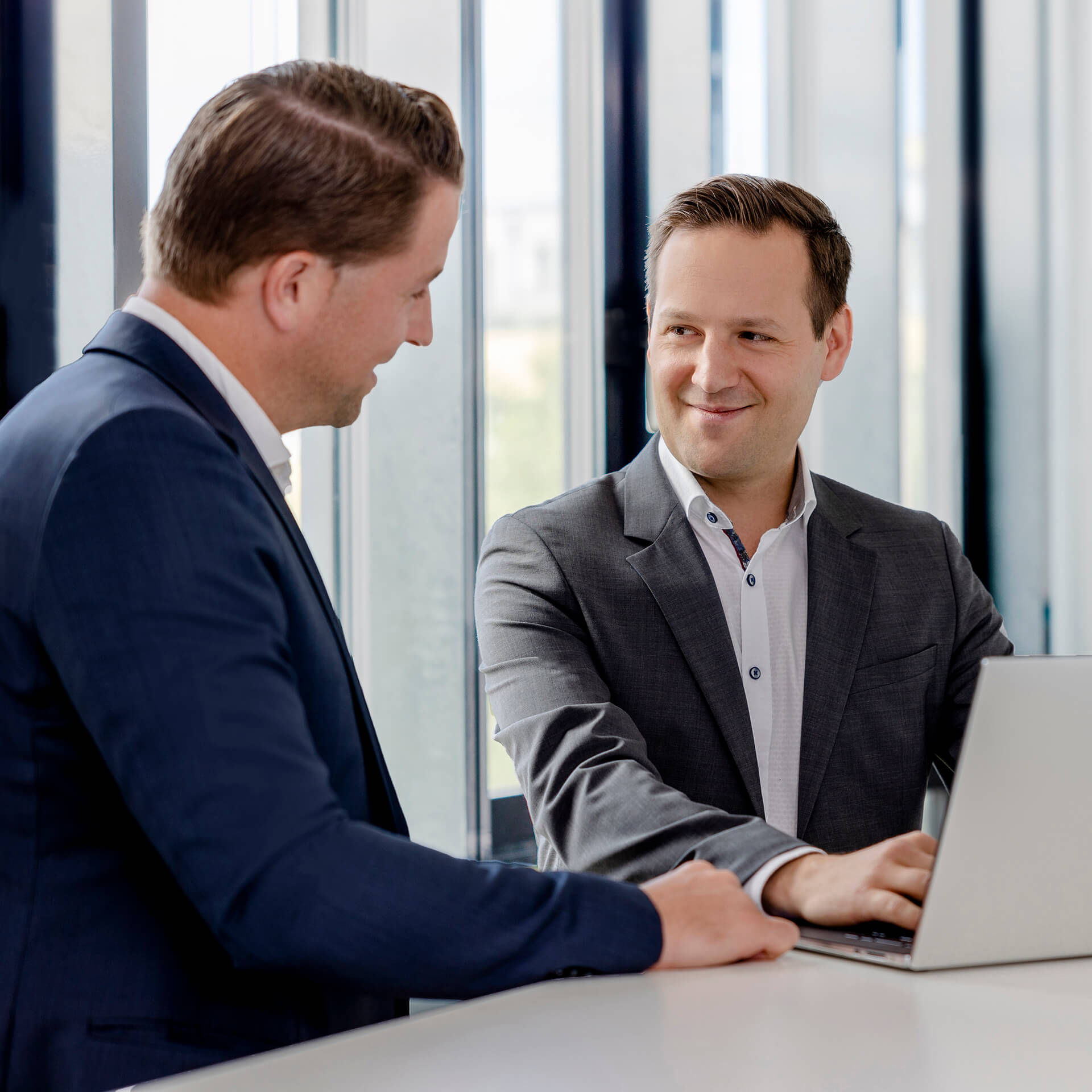 Two lawyers from activeMind.legal talk about necessary data protection measures for a client